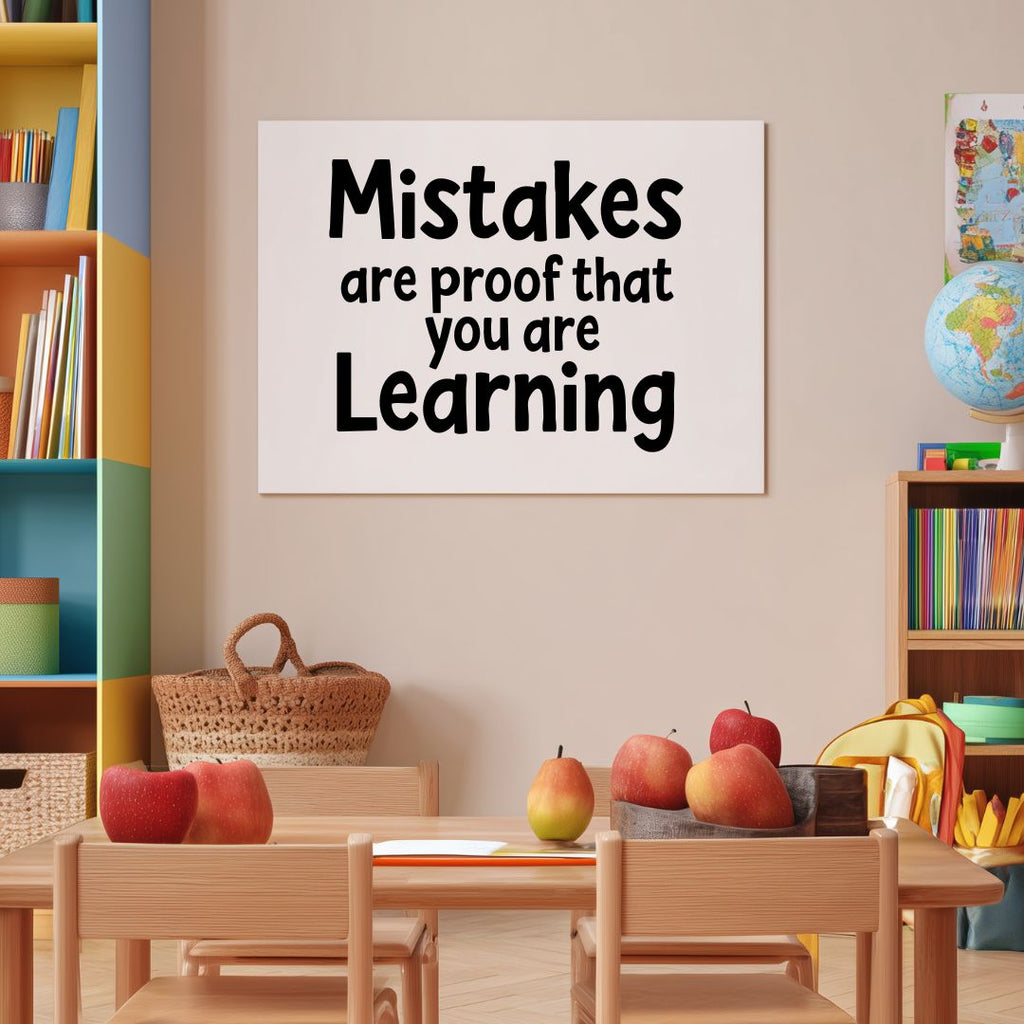 Classroom setting with a motivational poster "Mistakes are proof that you are Learning", books, and apples on a table.