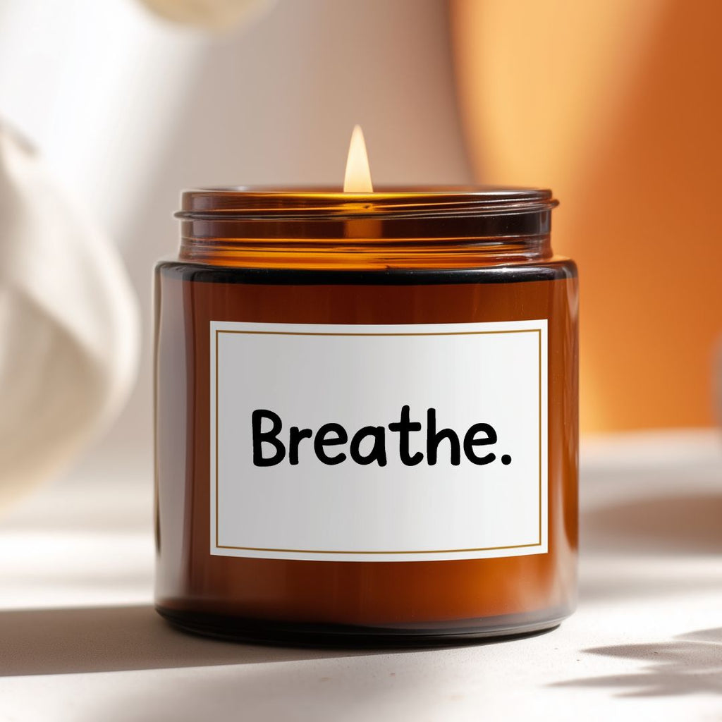 Candle in an amber jar with a 'Breathe' label on a neutral background