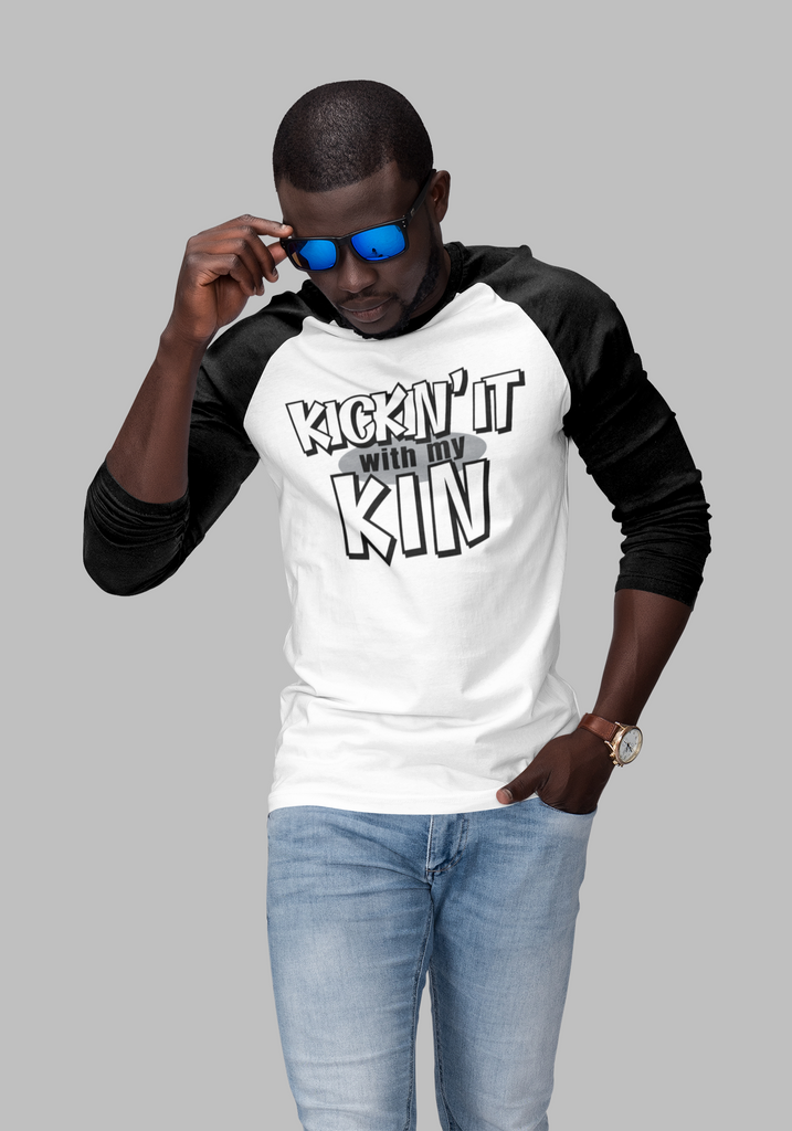 man with white raglan shirt with black sleeves displaying the kickin it with my kin design